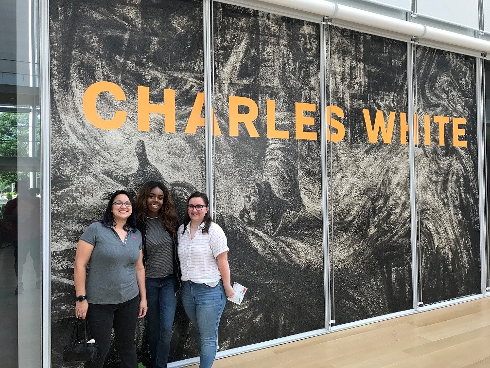students standing outside of an exhibit